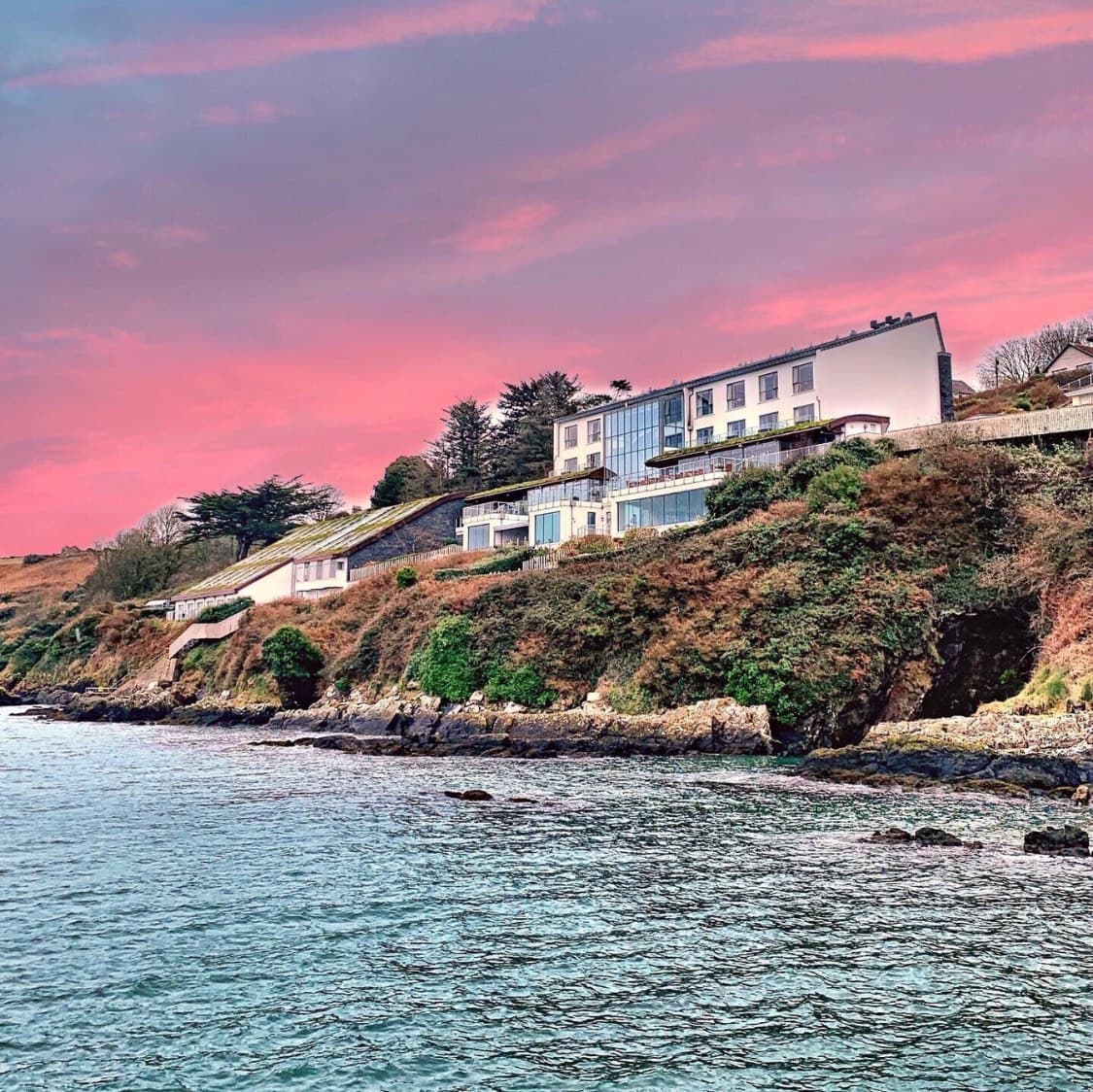 Cliff House Hotel above Ardmore Bay at sunset